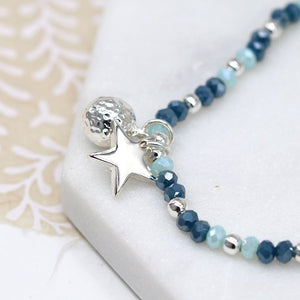 Silver plated and blue bead bracelet with star and ball