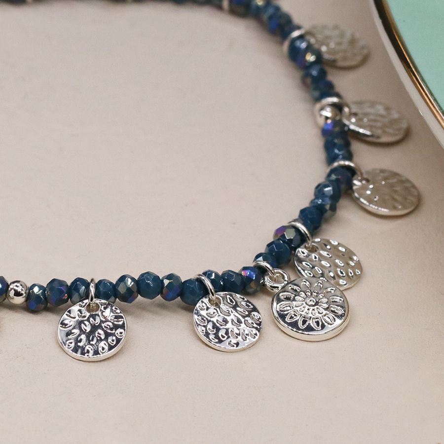 Blue beaded bracelet with silver hammered discs